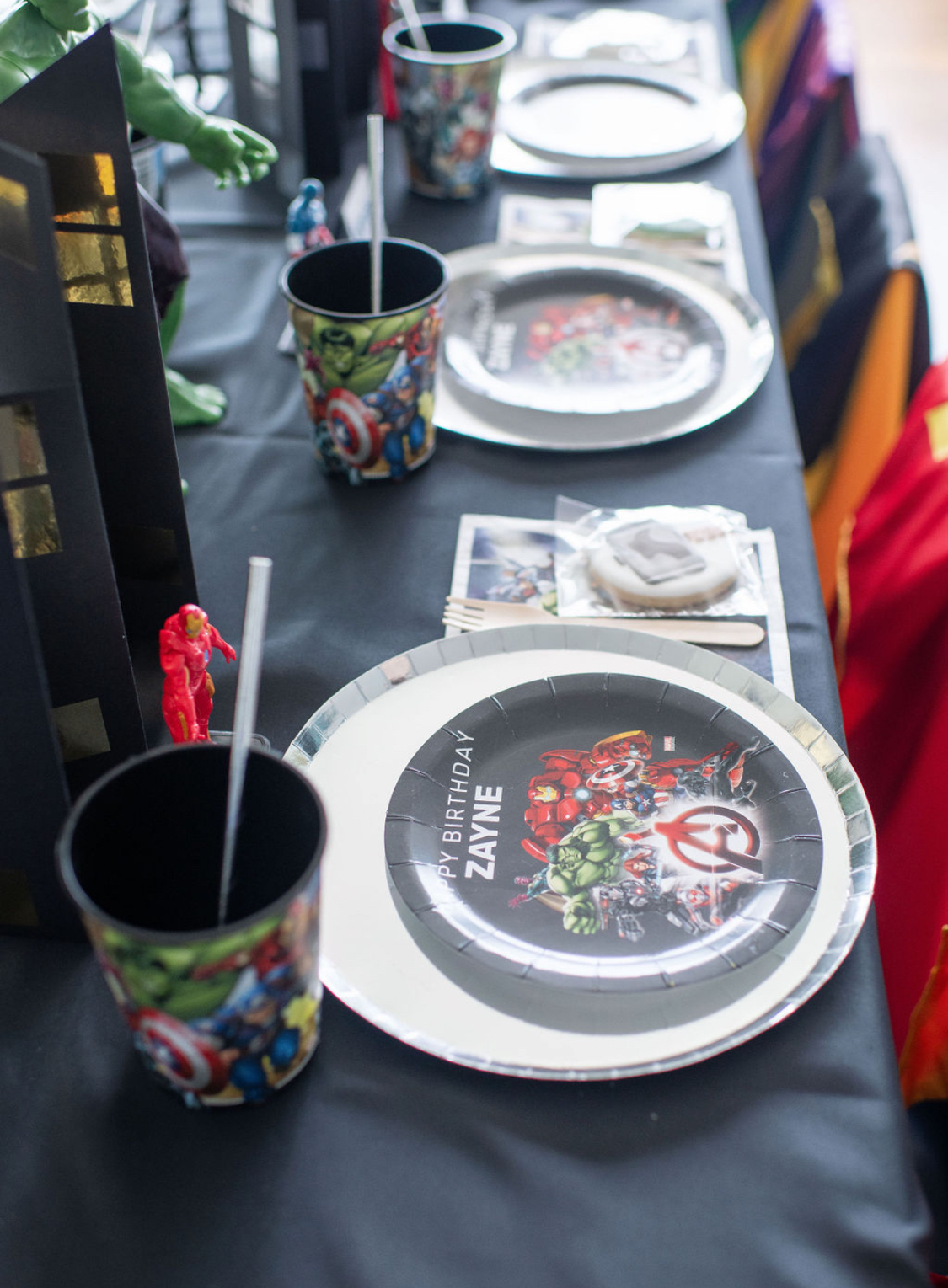 Avengers place setting with figures and black cityscape centerpiece